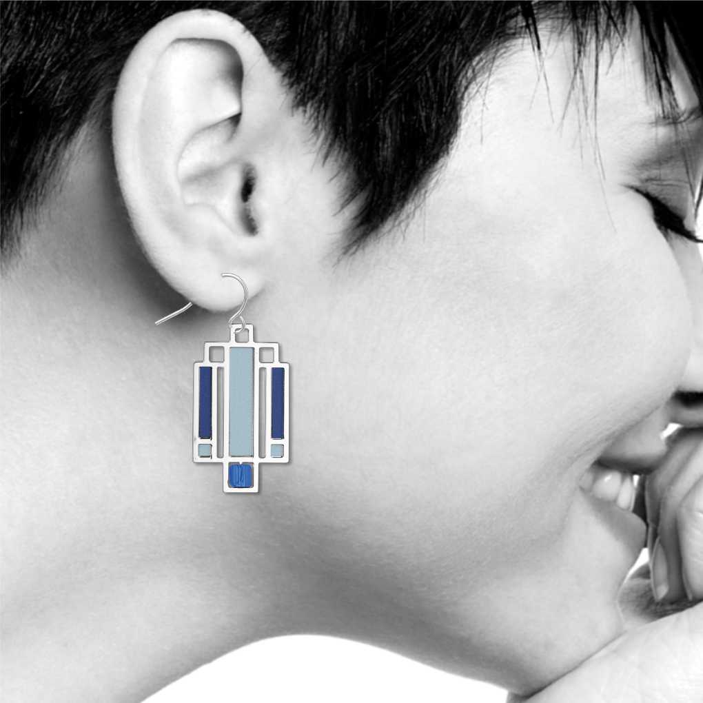 Willits Lightscreen Earrings: silver-tone geometric earring inspired by Frank Lloyd Wright's Willits House lightscreen design, featuring light blue and dark blue accents shown on model
