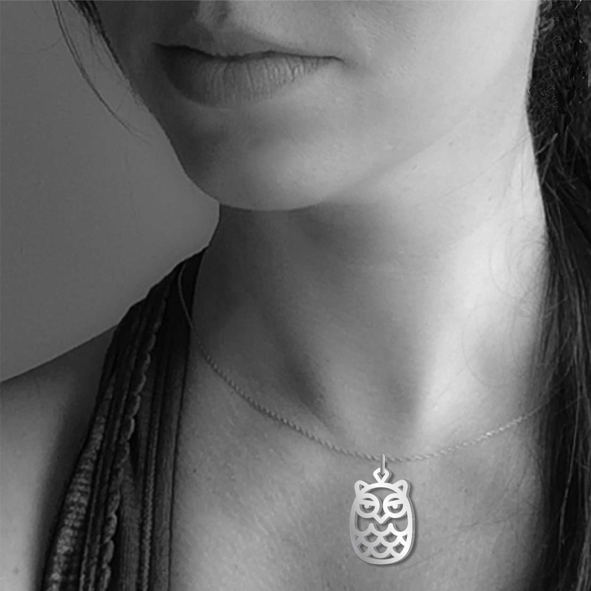 Model wearing the Hoot Owl pendant necklace featuring a silver-tone owl design inspired by the Great Horned Owl.