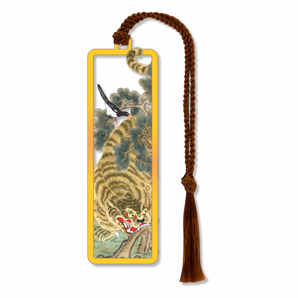 The Tiger & The Magpie Metal bookmark inspired by Asian folklore, featuring symbols of power, strength, protection, good news, and prosperity to attract good fortune in the coming year showing tiger resting near tree with magpie bird perched above with brown braided tassel for book lovers gifts.