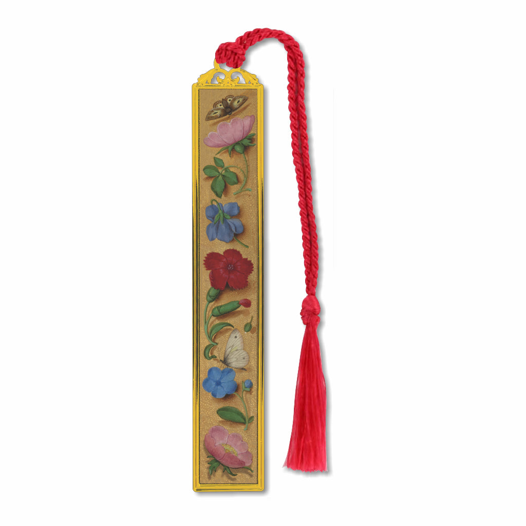 A brass metal bookmark with a medieval floral design, featuring a red tassel.