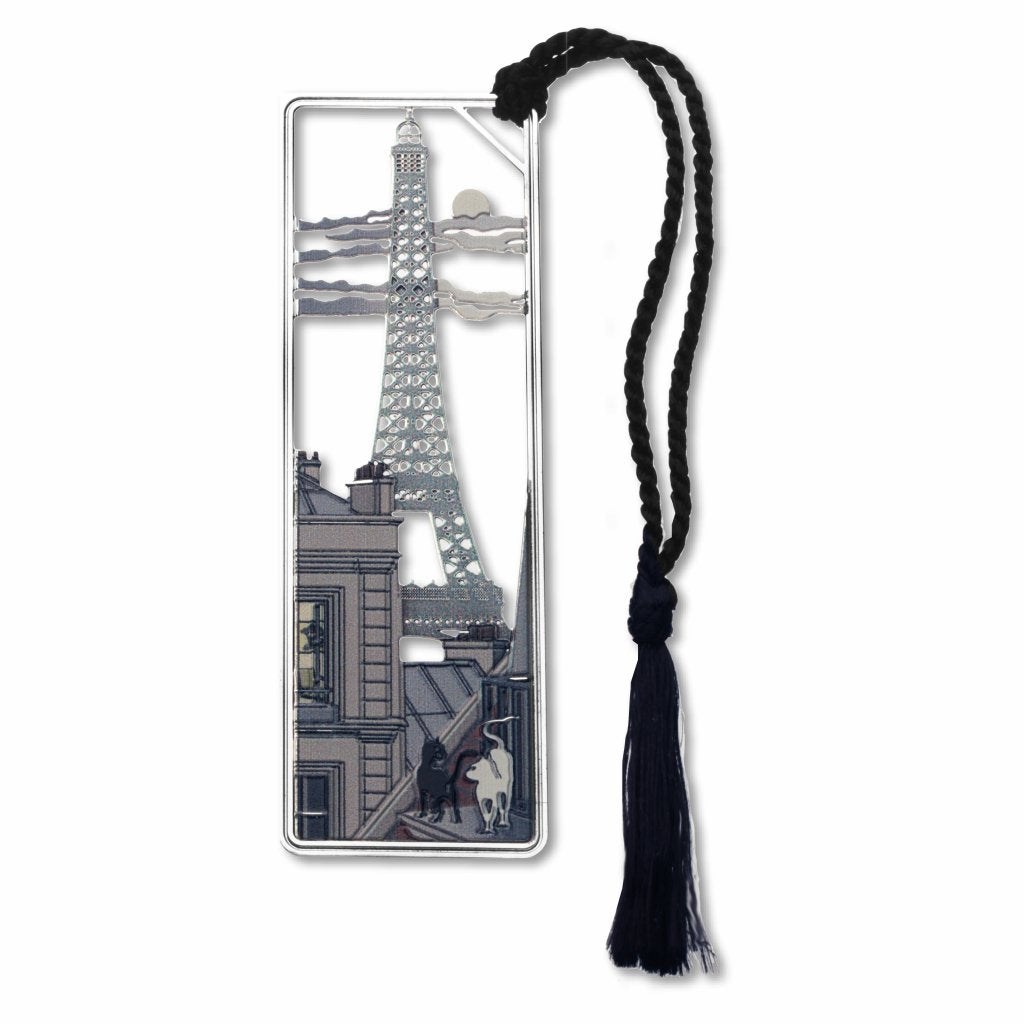 A metal bookmark featuring an image of the Eiffel Tower with two cats and a moon view, attached to a black braided tassel.