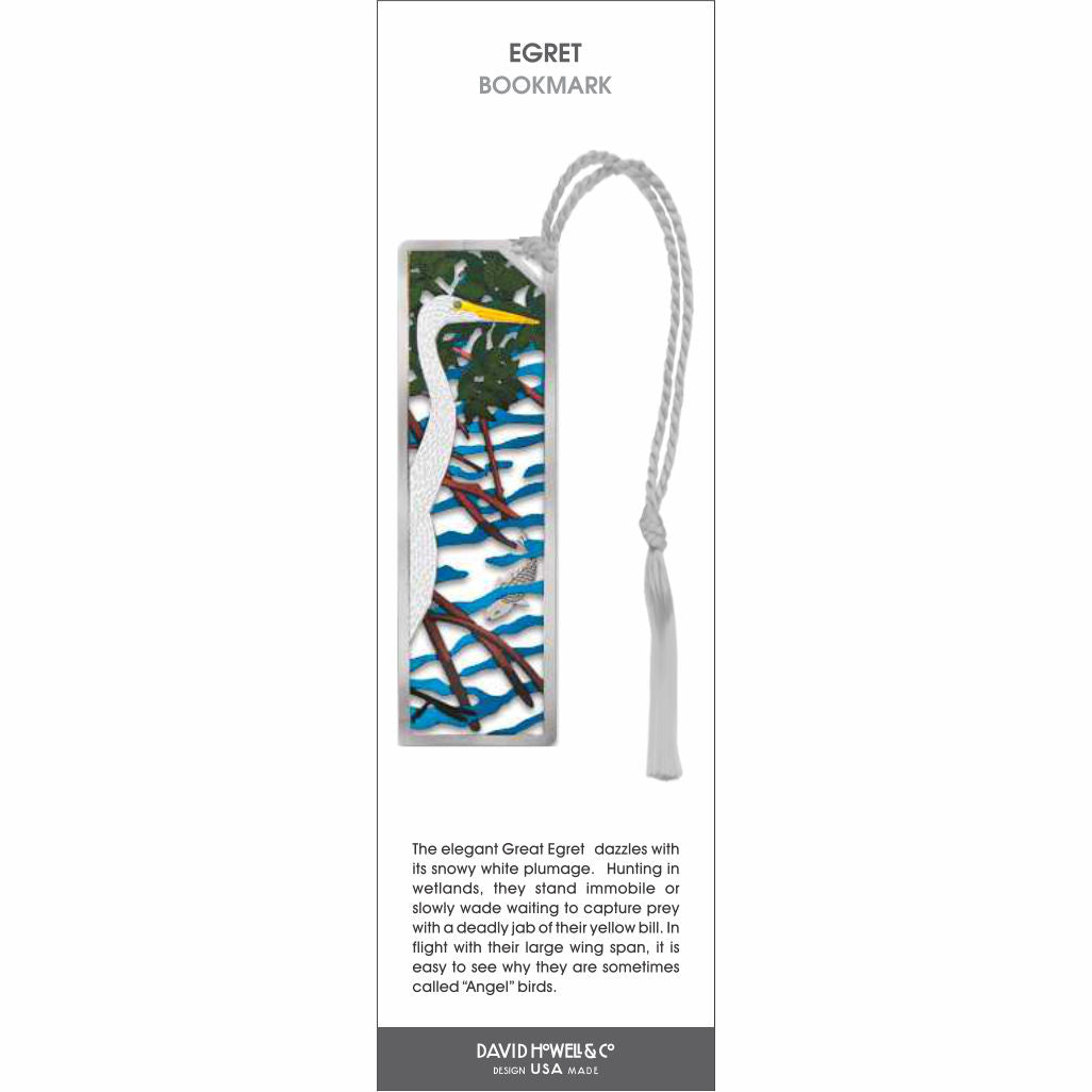 Egret’ bookmark featuring a white egret with a yellow beak standing among branches over water, with a light gray tassel.
