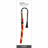 Japanese Sword & Sheath Bookmark featuring a katana-style design with a red scabbard accented by gold stripes, a detailed handle, and a black braided tassel.