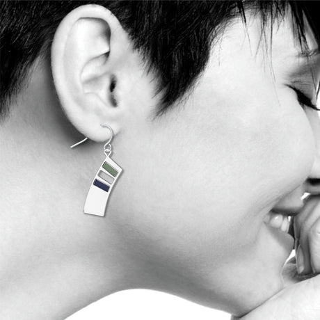 The Colors of Music abstract silver drop earring worn on ear with green and navy enamel accents inspired by Kandinsky’s geometric artwork