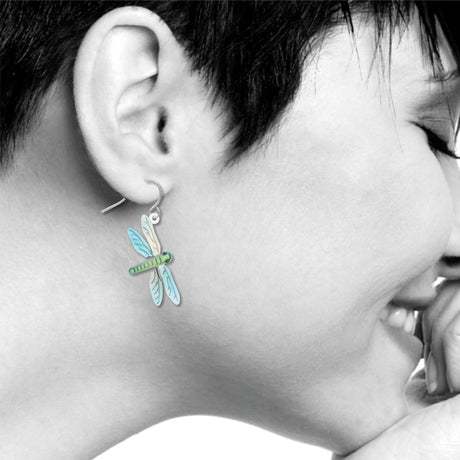 Dragonfly earrings: green and blue dragonfly drop earring worn on ear.