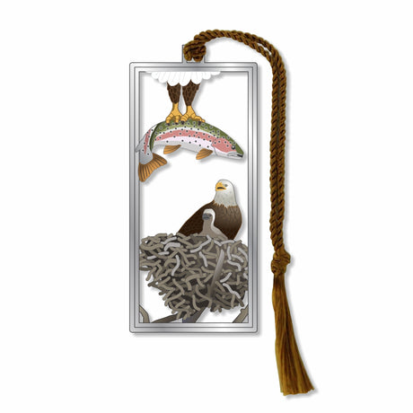 A metal bookmark featuring an illustration of an eagle with a fish in its beak, and a nest with eaglet in the background, attached to a brown  braided tassel for a museum-quality gift for animal and nature lovers, national park goers, bird watchers and readers.