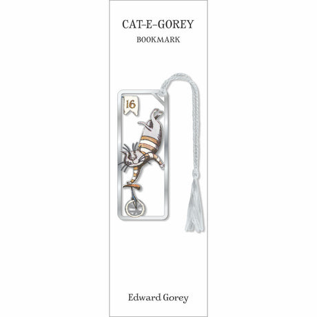 A book bookmark card for 'CAT-E-GOREY' featuring an illustration of a cat on a unicycle in silver and gold tones, with a white tassel, and the name Edward Gorey printed at the bottom.