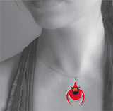 Model wearing the Cardinal pendant necklace featuring a vibrant red stylized bird charm inspired by Charley Harper’s minimalist nature artwork.