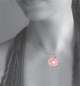 Model wearing the Single Blossom necklace, featuring a delicate silver-tone pendant with a soft pink sakura-inspired cherry blossom design.
