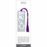 Sego Lily metal bookmark with white flowers, green stems in a silver frame, and a purple tassel.