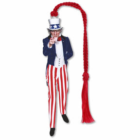 A silver metal bookmark with an illustration of Uncle Sam wearing a top hat and striped trousers, holding a red wand, with braided red tassel.